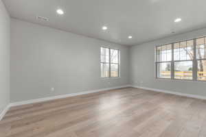 Unfurnished room with light wood-type flooring