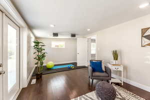 Sitting room with dark wood-type flooring