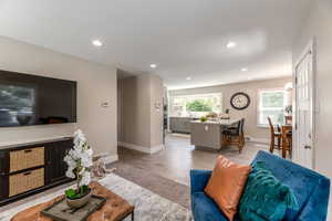 Living room featuring light wood-type flooring and sink