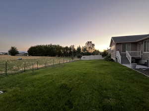 Yard at dusk featuring a rural view