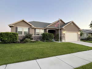 Ranch-style home with a yard and a garage