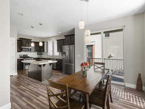 Dining area featuring dark wood-type flooring and granite counter tops