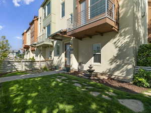 Exterior space featuring a lawn and a balcony