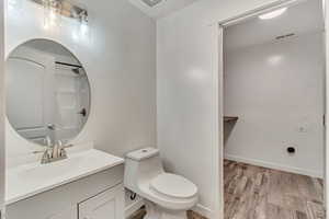 Bathroom featuring toilet, hardwood / wood-style flooring, and vanity