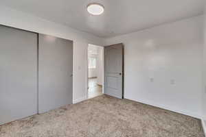 Unfurnished bedroom with carpet and a closet