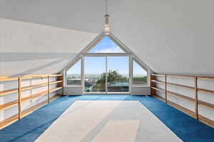 Bonus room featuring lofted ceiling and carpet