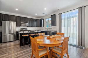 Interior space with appliances with stainless steel finishes, hardwood / wood-style flooring, and a kitchen island