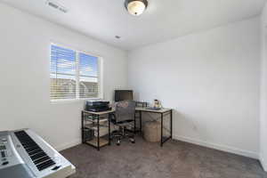 Office area with dark carpet