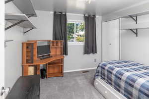 Bedroom with a closet and carpet floors