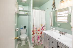 Bathroom with vanity, toilet, and walk in shower