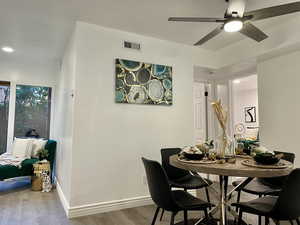 Dining space with wood-type flooring and ceiling fan