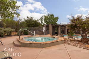 View of pool featuring a patio area and a hot tub