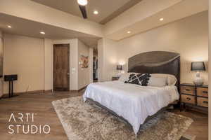 Bedroom with hardwood / wood-style flooring, a spacious closet, and ceiling fan