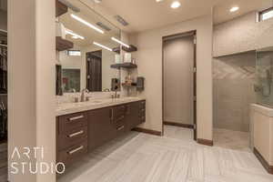 Bathroom with a tile shower and vanity