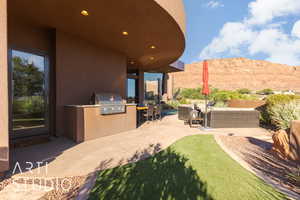 View of patio / terrace featuring a mountain view, grilling area, and an outdoor kitchen