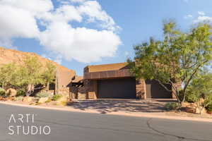 Pueblo-style home featuring a garage