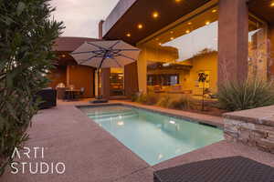 Pool at dusk with a patio