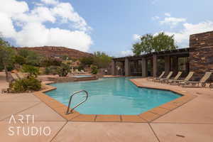 View of swimming pool featuring a mountain view, a hot tub, and a patio area