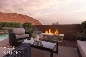 Patio terrace at dusk with an outdoor living space with a fire pit and a mountain view