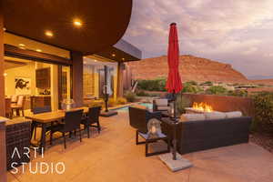 Patio terrace at dusk featuring a mountain view and an outdoor living space