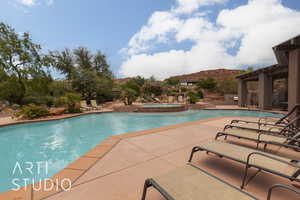 View of swimming pool with a community hot tub and a patio area