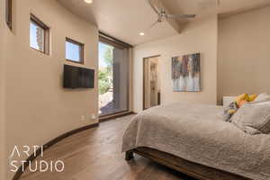 Bedroom featuring dark wood-type flooring and ceiling fan