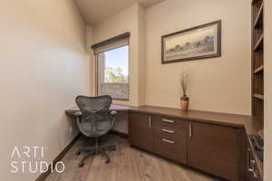 Office with light hardwood / wood-style floors