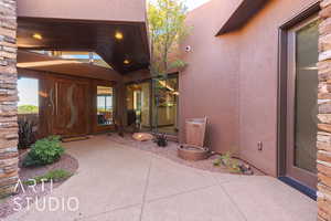 Doorway to property featuring a patio area