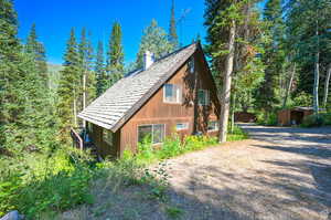 View of side of property featuring a storage shed