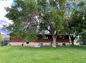 Back of house featuring a lawn