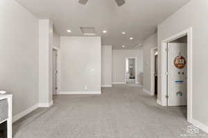 Living space featuring light colored carpet, and a textured ceiling