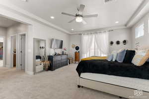 Primary Bedroom with a tray ceiling, ceiling fan, and light carpet