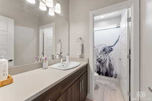 Full Bathroom with vanity, toilet, and a shower