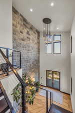 Staircase with a chandelier and hardwood / wood-style flooring