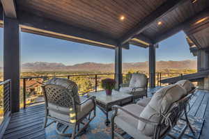 Wooden deck featuring a mountain view and an outdoor living space