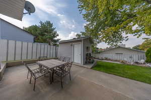 View of patio featuring an outbuilding