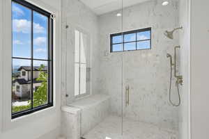 Bathroom with a marble finish shower