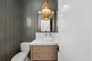 Half bathroom with vanity and toilet