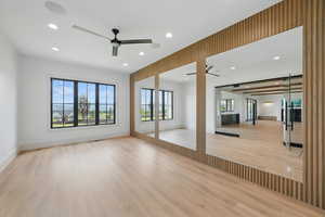 Spare room with ceiling fan, wood finished floors, recessed lighting, and baseboards