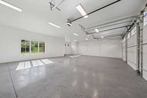 Garage with baseboards and a garage door opener