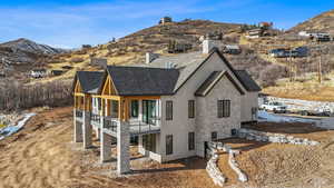 Rear view of house with a mountain view and a balcony