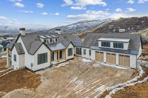 Back of property featuring a garage and a mountain view