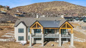 Rear view of property featuring a mountain view and a balcony