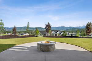 View of patio featuring a fire pit and a mountain view