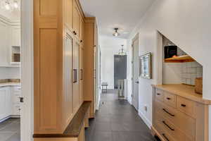 Hall with dark tile patterned flooring