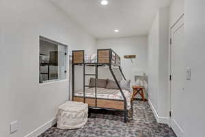 Bedroom featuring dark colored carpet