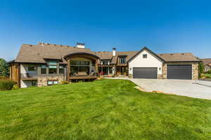 View of front of house with a garage and a front lawn