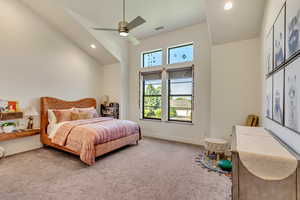 Bedroom featuring a towering ceiling, ceiling fan, and carpet floors