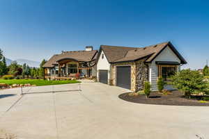 View of front of home featuring covered porch and a garage