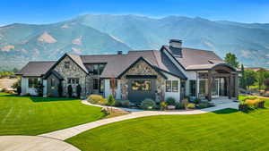 View of front of house with a front lawn and a mountain view